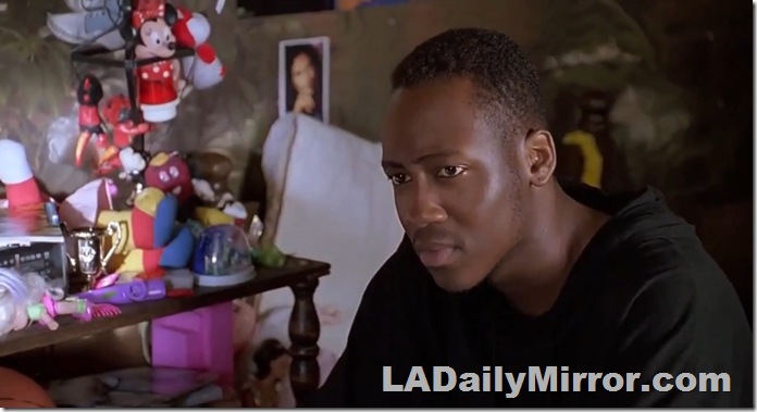 Man in shirt, seated. 