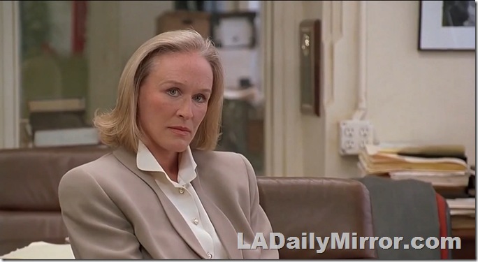 Blond woman glaring in 1990s power suit. Danger! Danger! 