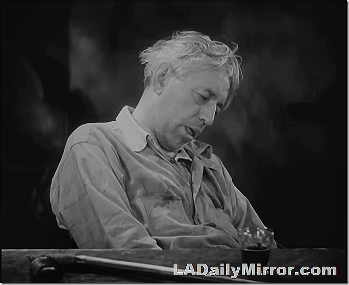 Older man with messy hair. Asleep at a table. 