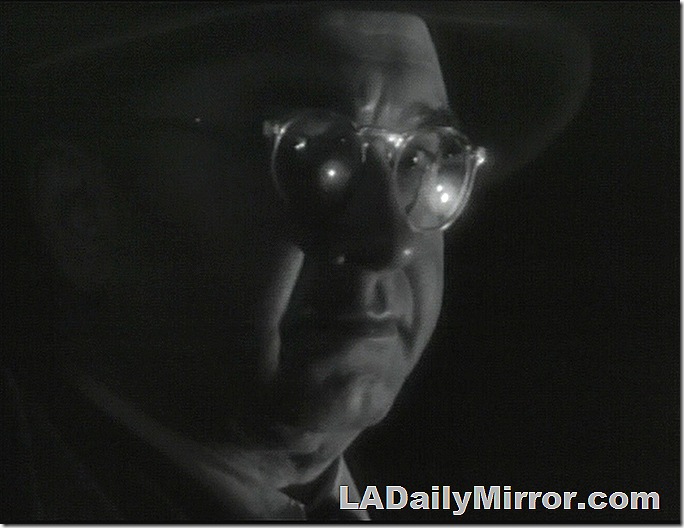 Closeup of man wearing glasses and a hat. 
