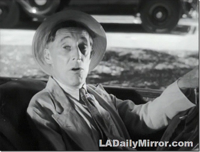 Man in hat at wheel of car