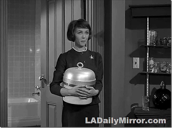 Woman in fashionable dress, with necklace and broach. 