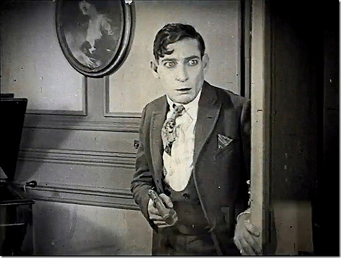 Man in three-piece suit holding a gun. Man in three-piece suit holding a gun.