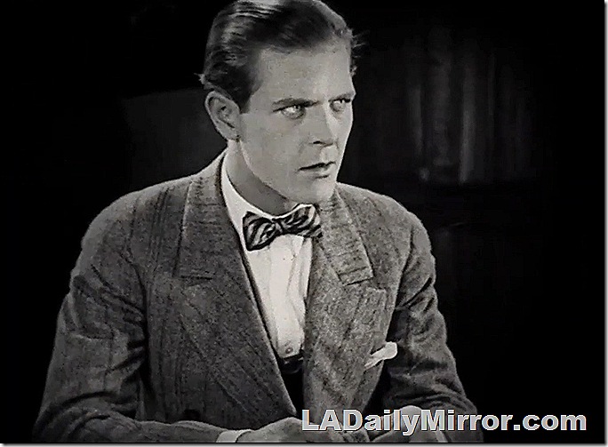 Man in coat and bowtie with serious expression. Man in coat and bowtie with serious expression.