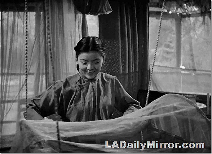 Woman looking at cradle. 