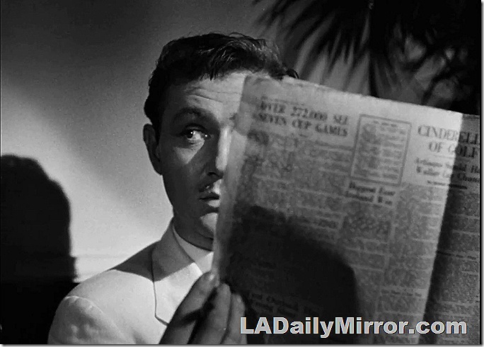 Man peering from behind newspaper. Mucho mysterioso!