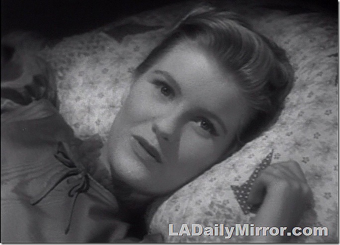 Woman with her head on a pillow. 