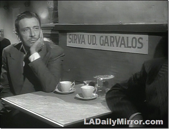 Man wearing a suit, sitting in a cafe, with a cup of coffee. Man wearing a suit, sitting in a cafe, with a cup of coffee.