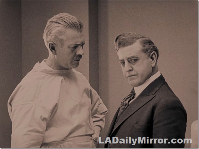 Man with white hair in surgical gown talking to man in suit and tie. Man with white hair in surgical gown talking to man in suit and tie.