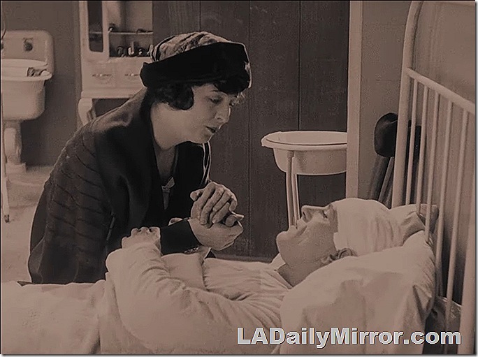 Man in bed, his head bandaged, talking to a woman at his bedside as they hold hands. Man in bed, his head bandaged, talking to a woman at his bedside as they hold hands.