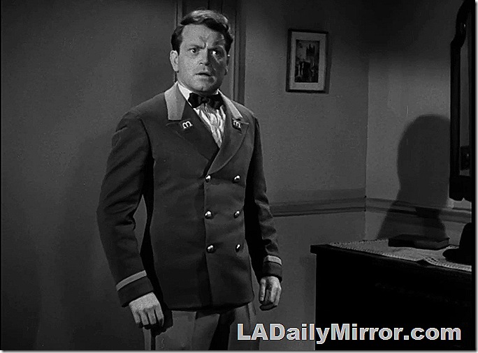 Surprised man wearing bellboy uniform. 