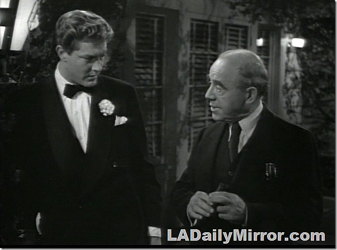 Younger man in tuxedo and bow tie talking to older man in three-piece suit. Younger man in tuxedo and bow tie talking to older man in three-piece suit.