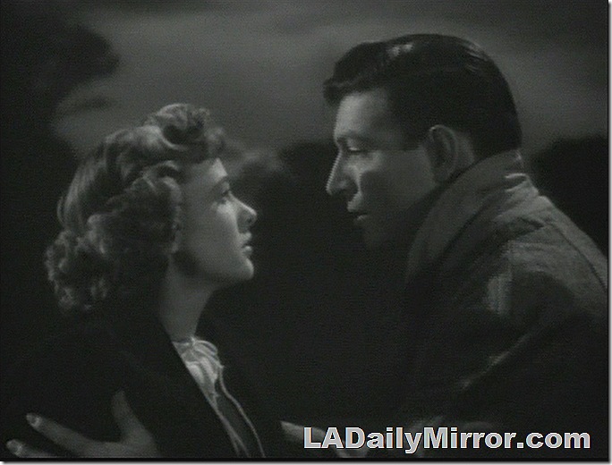 Man and woman facing each other at night. Both are wearing coats. Clouds in the background. Man and woman facing each other at night. Both are wearing coats. Clouds in the background.