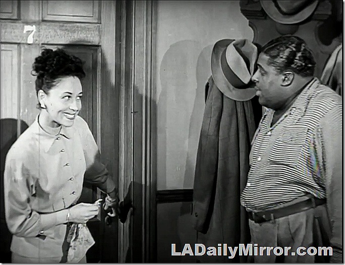 Woman standing in front of door. Smiling at man. Woman standing in front of door. Smiling at man.