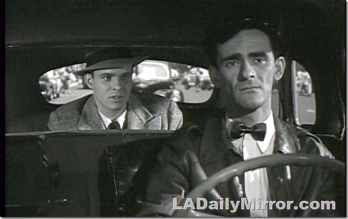 Cabdriver in cap and leather jacket with small bow tie. A man is riding in the backseatm, wearing an overcoat and hat. Cabdriver in cap and leather jacket with small bow tie. A man is riding in the backseatm, wearing an overcoat and hat.
