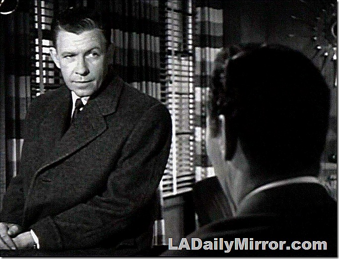 Over the shoulder shot of Back of the Head Guy facing a man in a coat, tie and overcoat. Over the shoulder shot of Back of the Head Guy facing a man in a coat, tie and overcoat.