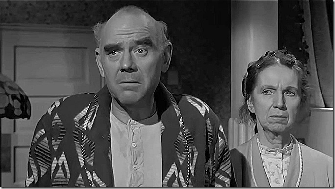 Bald man in bathrobe, woman in robe with her hair in curlers. Bald man in bathrobe, woman in robe with her hair in curlers.