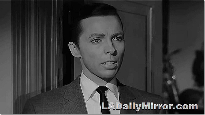 Mystery guest with short hair in a suit and tie. Mystery guest with short hair in a suit and tie.
