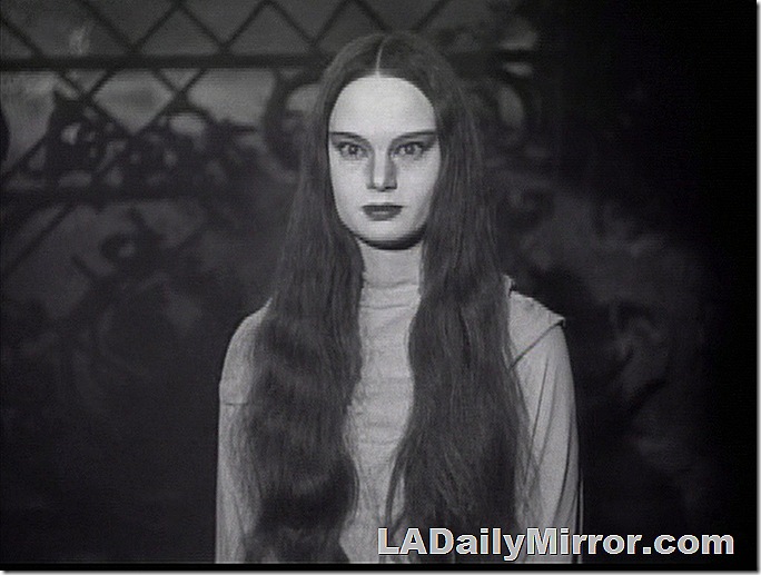 Woman with pale face and long hair. 