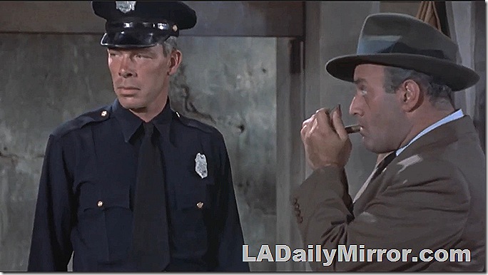 Man in police uniform and man lighting a cigar. Man in police uniform and man lighting a cigar.