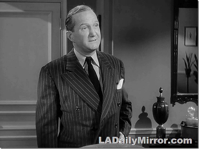 Man in double-breasted pinstripe suit with wide lapels