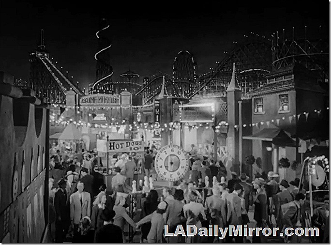 Crowd on midway of amusement park. 