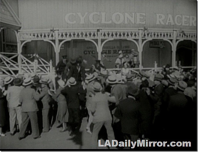 Crowd, men in straw boater hats and suits, at an amuseuement park 