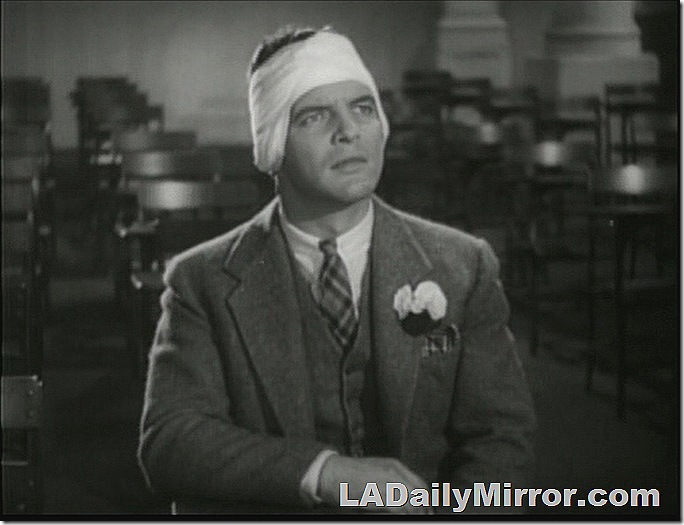 Man in three-piece suit with bandaged head. 