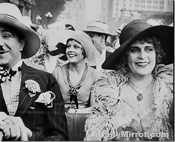 Woman in big hat and dressy outfit. 