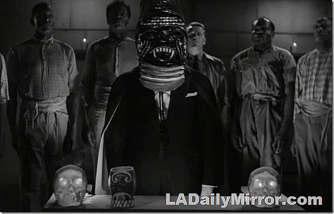 Weird ceremony with man in scary mask at altar with skulls
