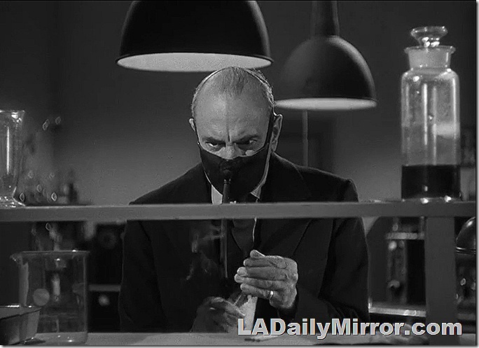 Mysterious scientist wearing a mask, at work in a laboratory Mysterious scientist wearing a mask, at work in a laboratory